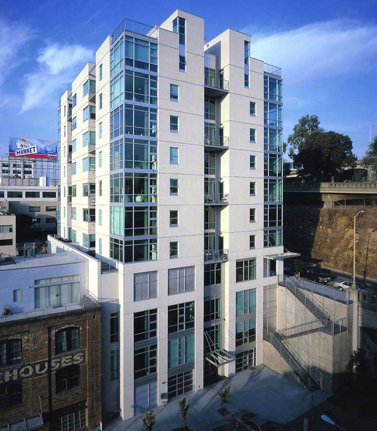 Exterior daytime view of 11-story residential structure modern architectural glass details