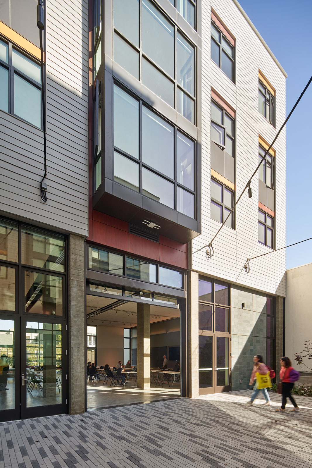 students walking towards entrance from courtyard 