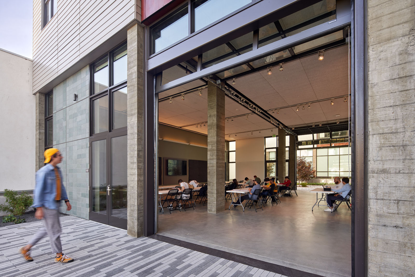 one student walking towards entrance from courtyard 