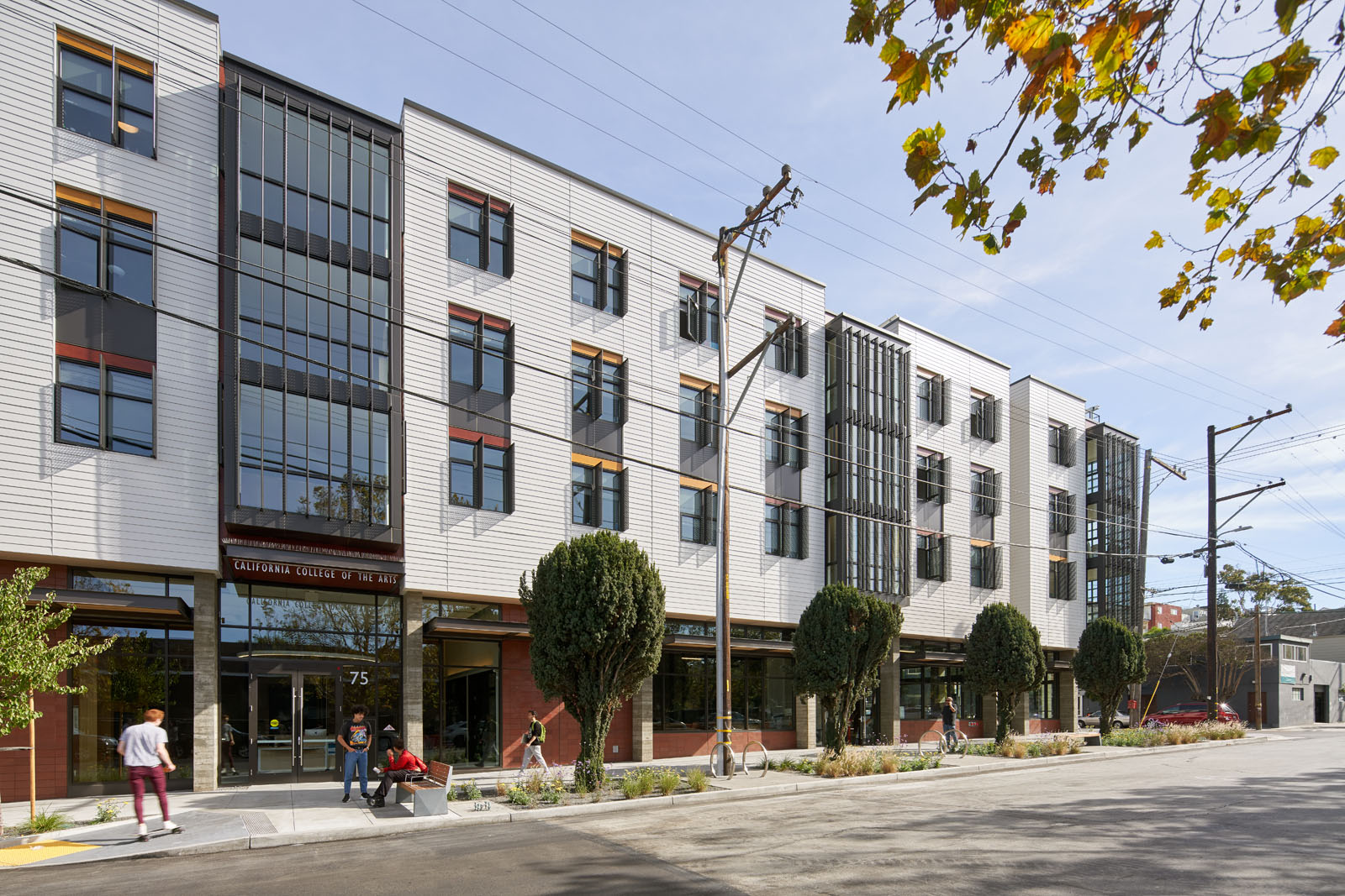 Exterior view of building from across the tree lined street 