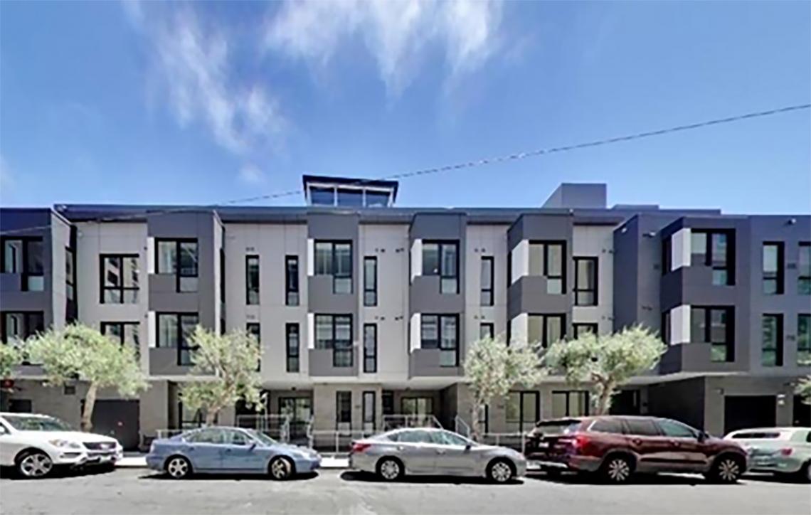 view of buildings on Minna street with cars parked in front