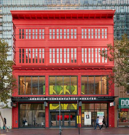 Exterior view of theater façade painted bright red along Market Street