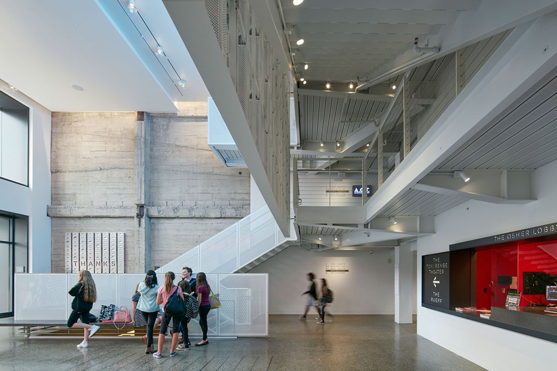 View of lobby with guests mingling and box office painted with bright red walls