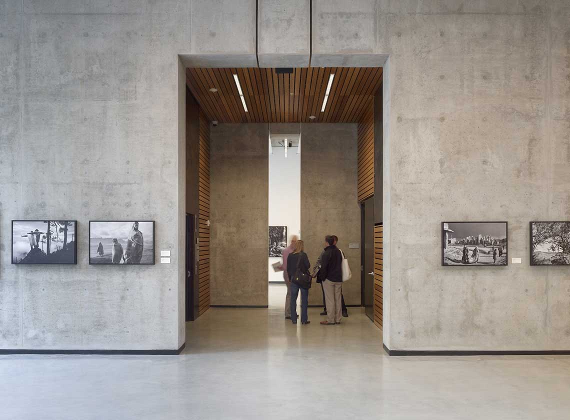 Interior view of lobby concrete walls and elevator lobby with wood cladding