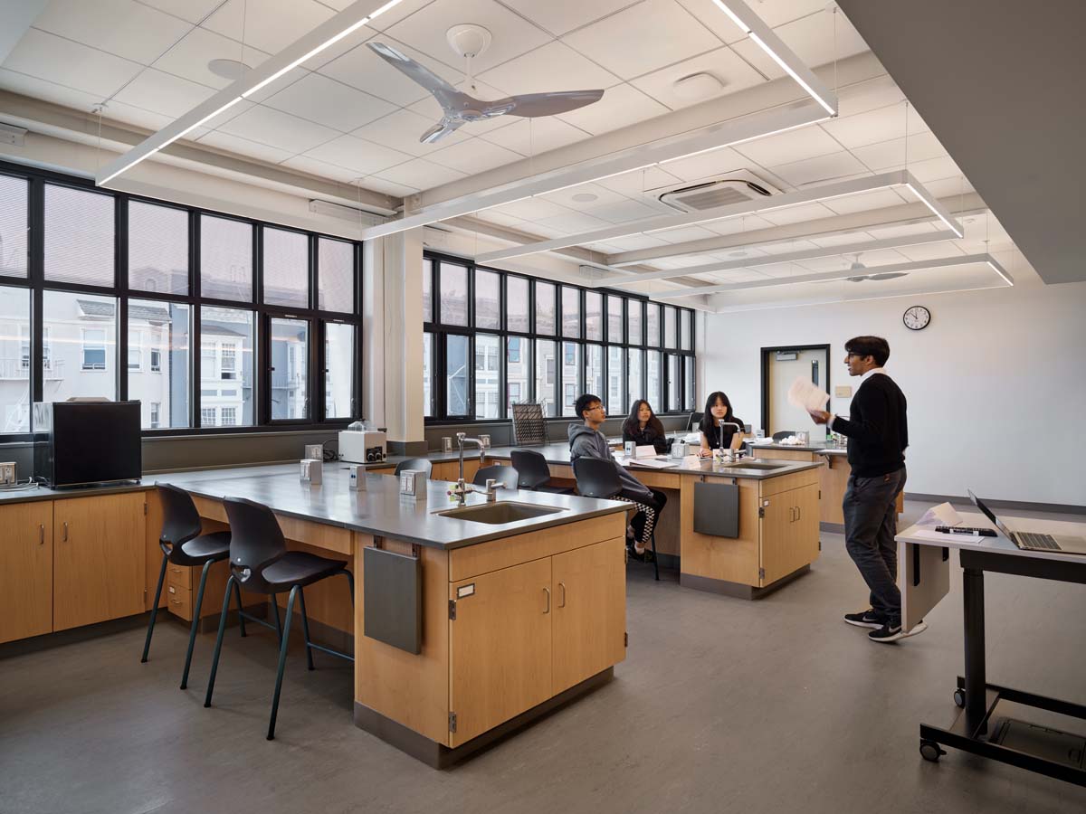 Classroom lab showing work stations, students and teacher.