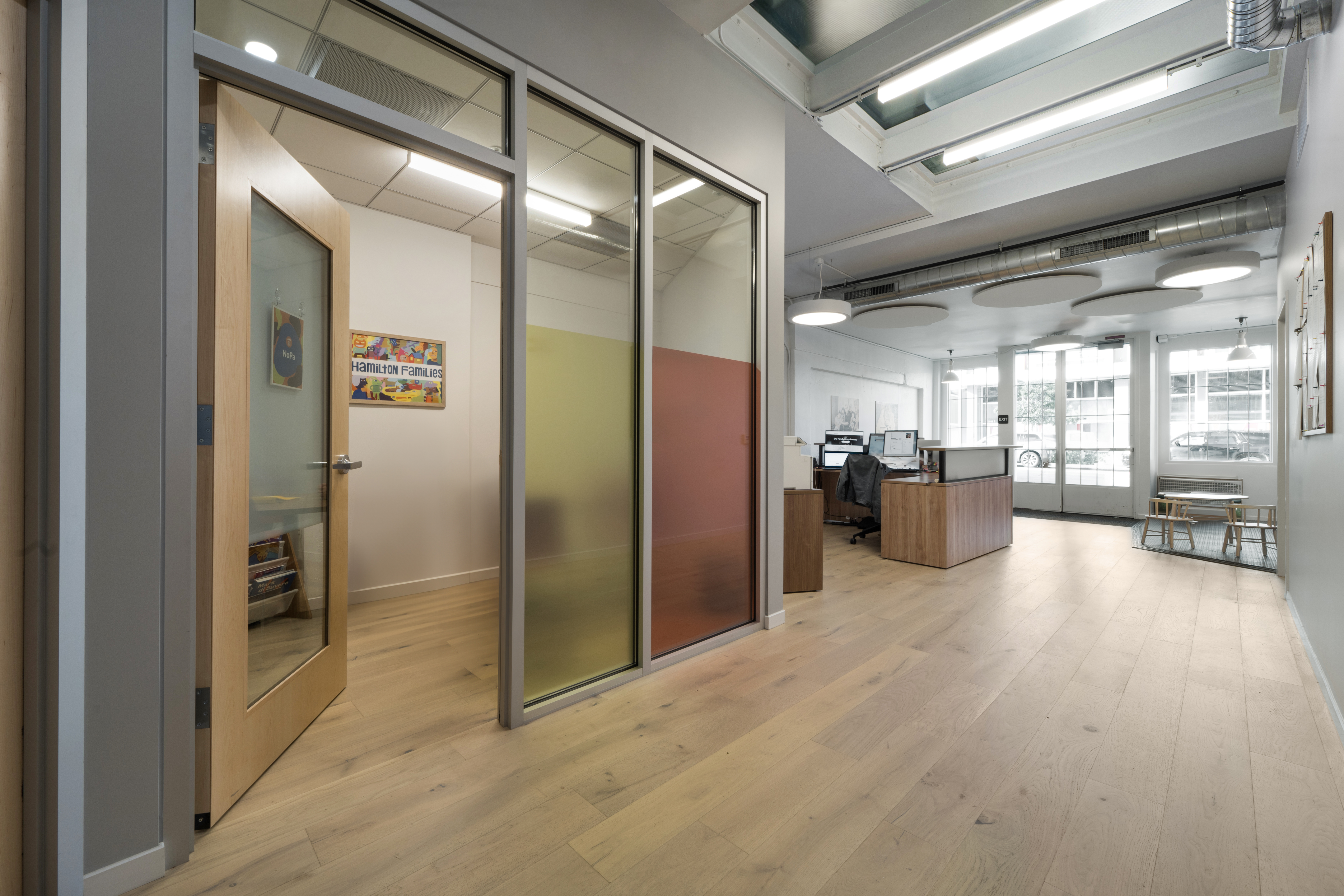 View of open office area leading to private office