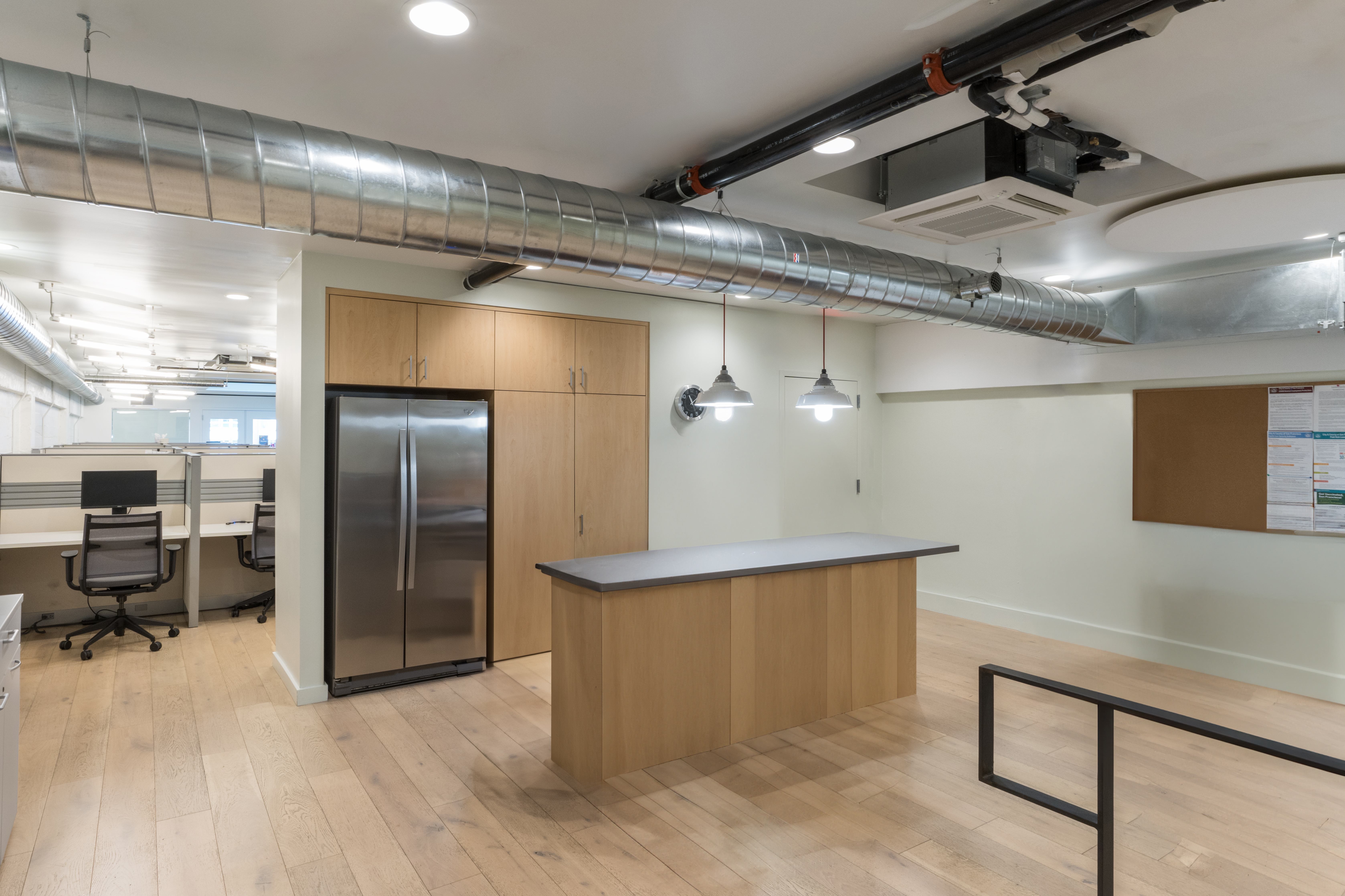 Kitchen area with counter, cabinets and refrigerator