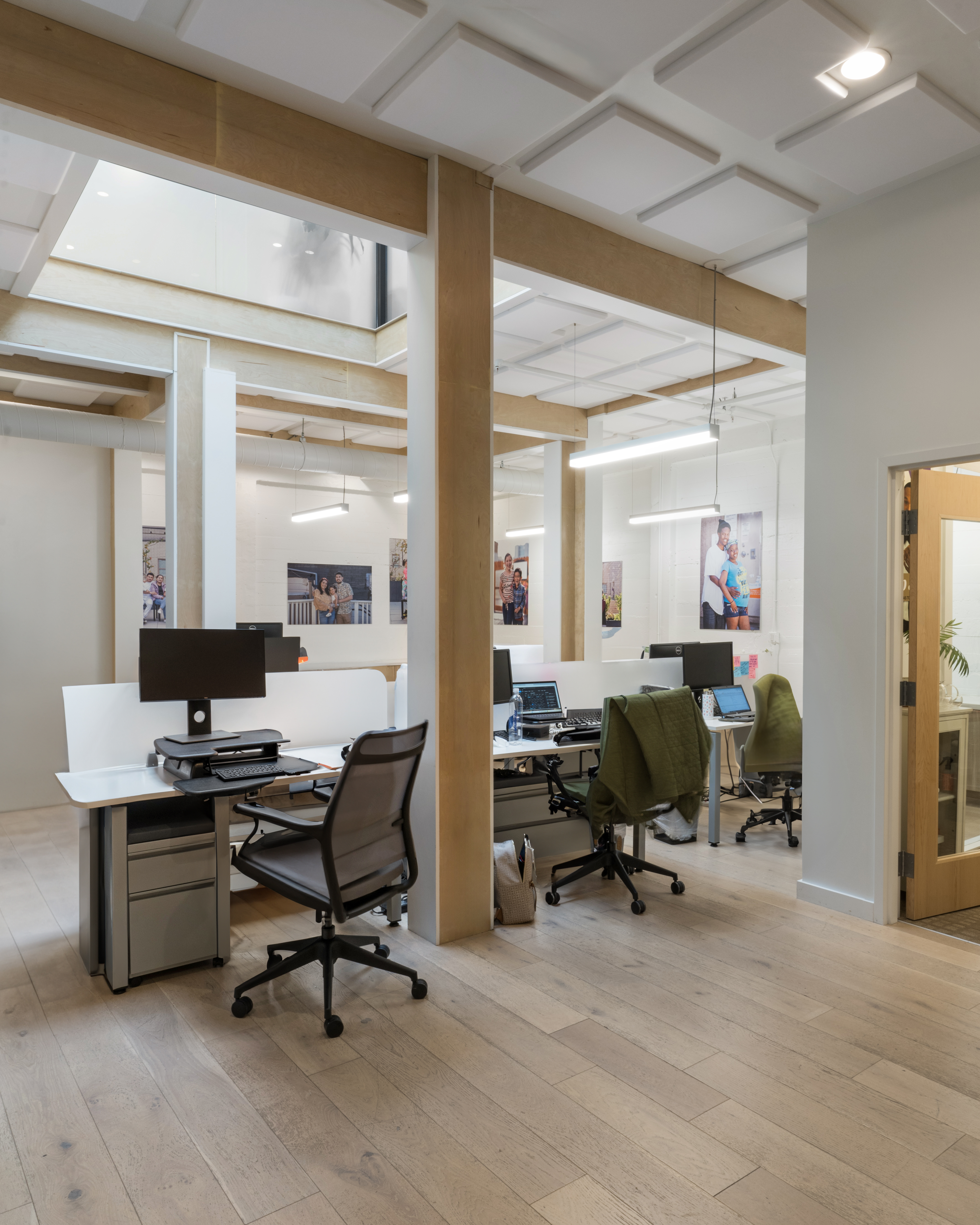 Workstations with desks, chairs, and monitors