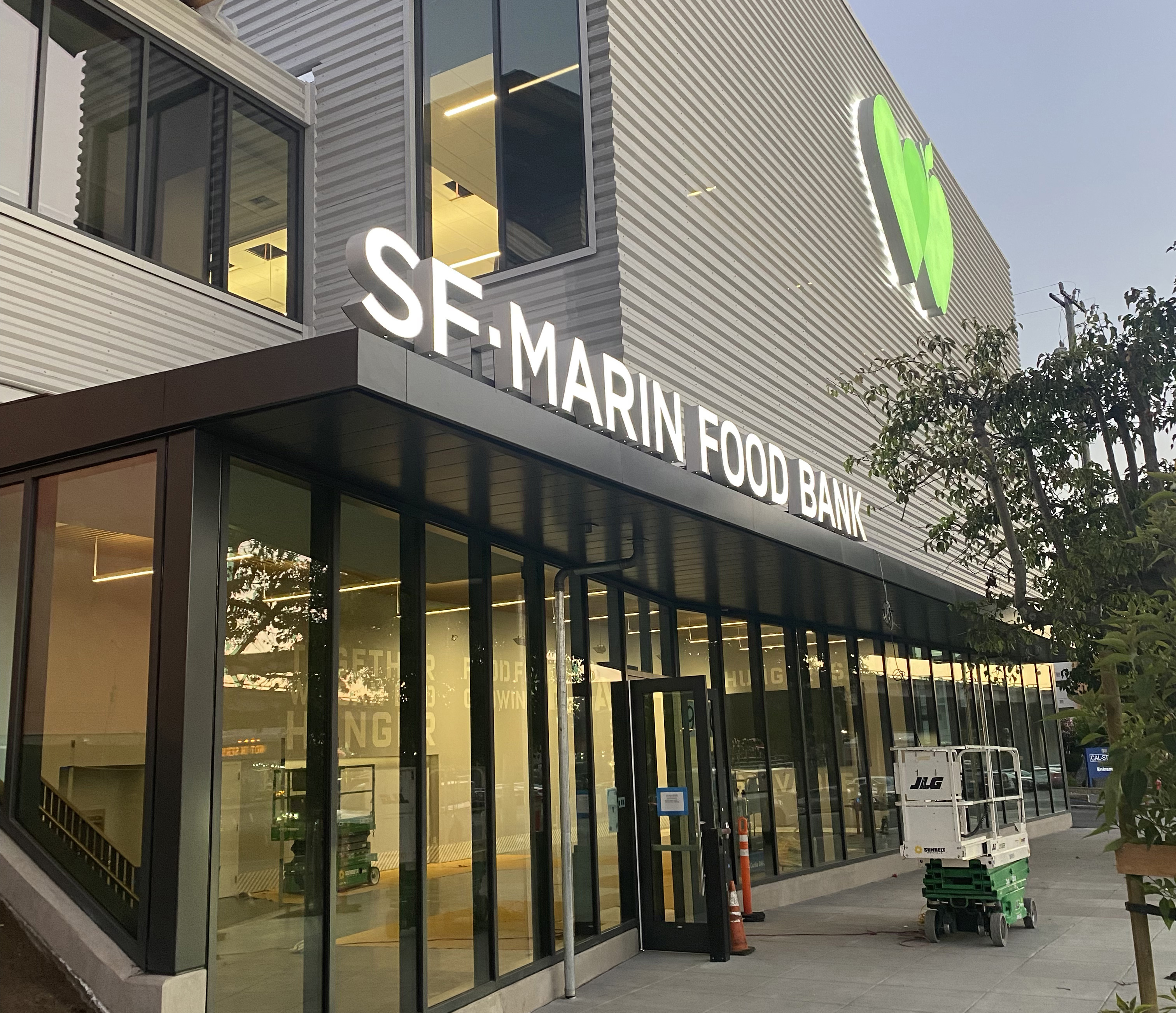 Exterior facade showing SF-Marin Food Bank signage above glassed entryway.