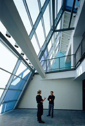 Interior view of modern glass atrium spanning lobby and corridor spaces on multiple floors