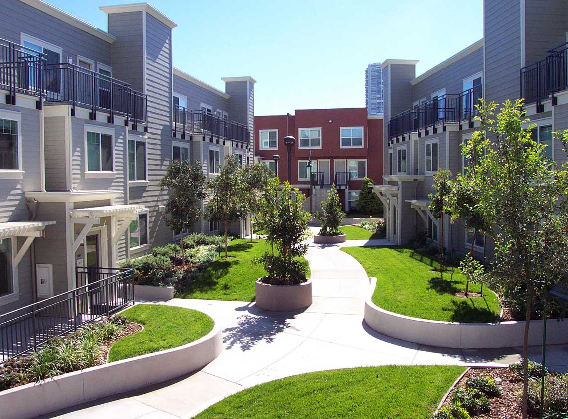 Exterior daytime view of landscaped courtyard with curving walkways and lawns