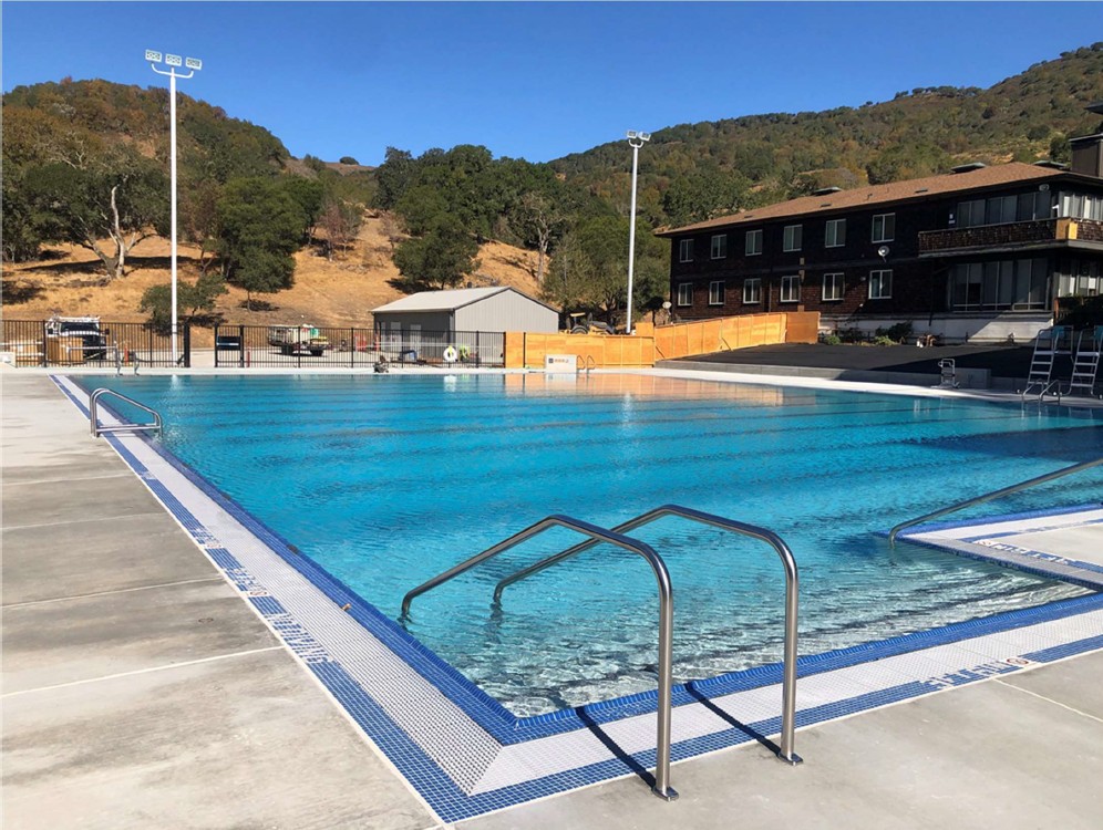 Exterior of pool with steps into pool with hand rails