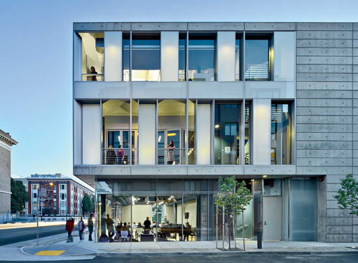 Exterior evening view of three-level SFJAZZ Center, with large windows and balconies looking into performance and lobby spaces