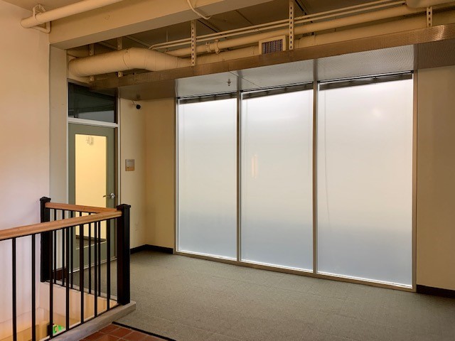 Entry area from comon area lobby showing froste window and glass door.