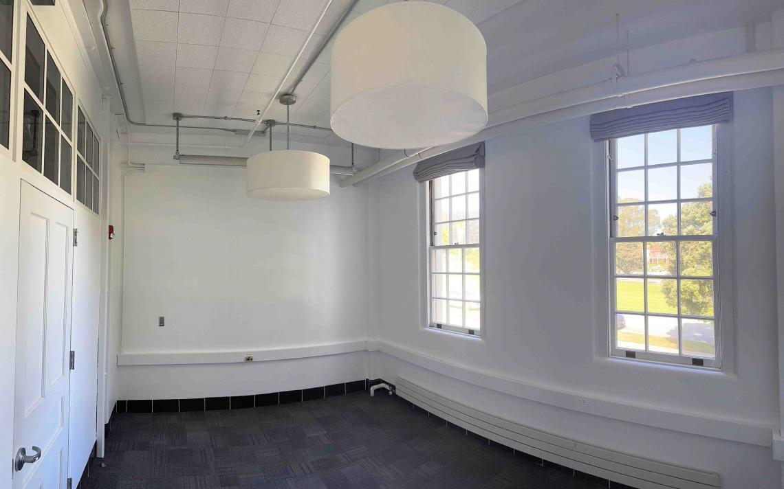image of unfurnished carpeted office with two windows