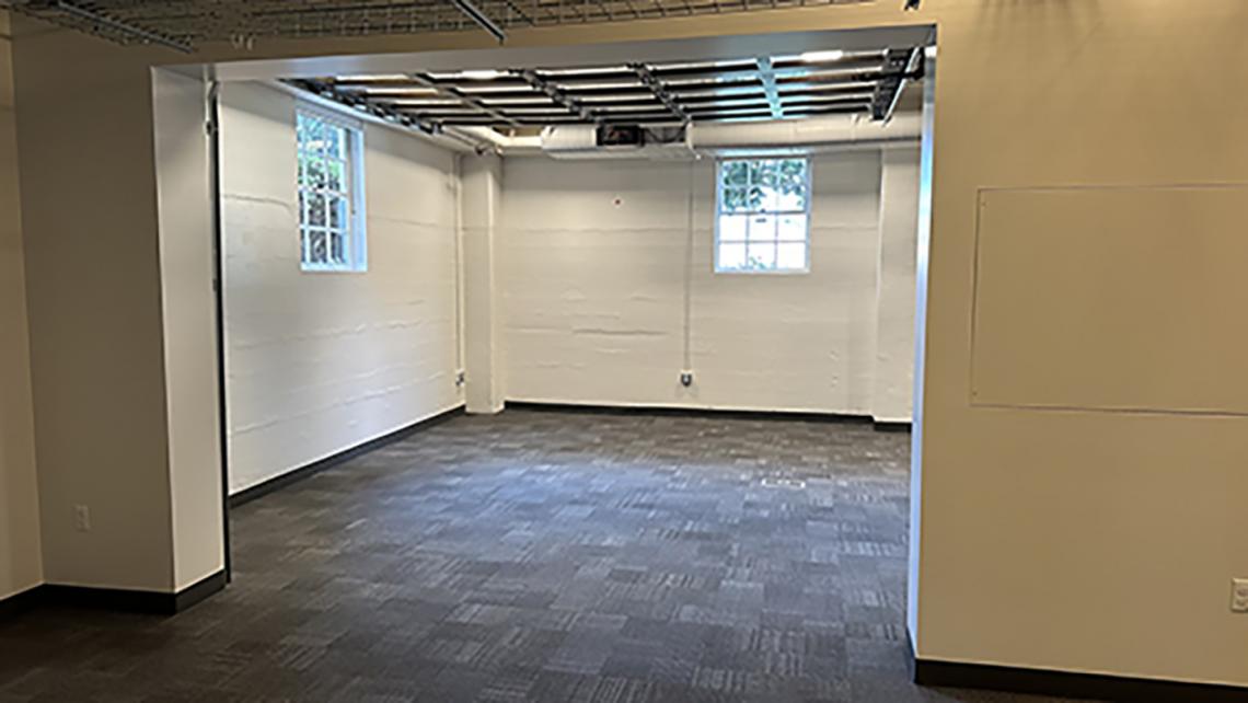 Photo of interior office space unfurnished showing two windows