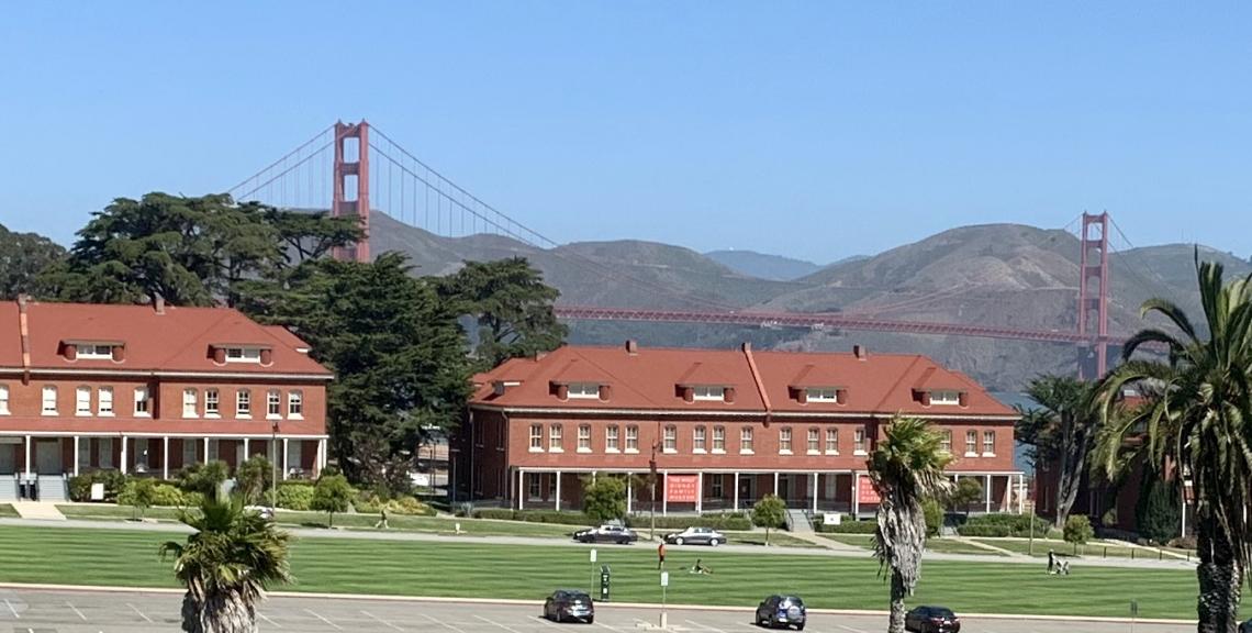 View of Main Post lawn, brick buildings and Golden Gate Bridge