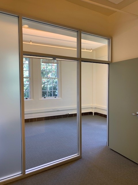 Entrance to Private office with glass wall and solid door