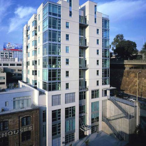 Exterior daytime view of 11-story residential structure modern architectural glass details