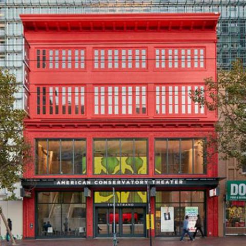 Exterior view of theater façade painted bright red along Market Street