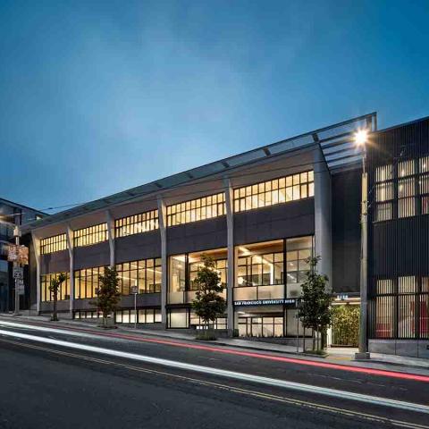 Exterior street view of Building at night.