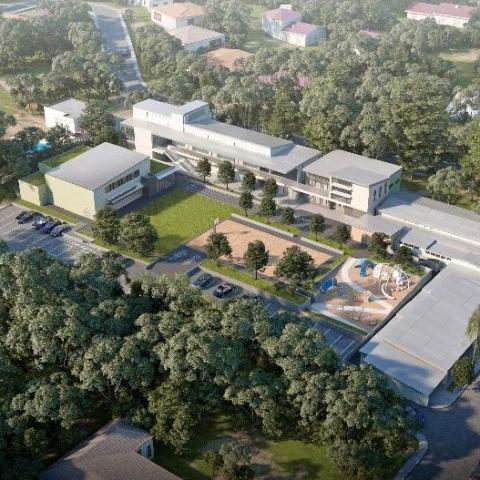 Bird's eye exterior rendering of school campus buildings, play area, basketball court, and lawn